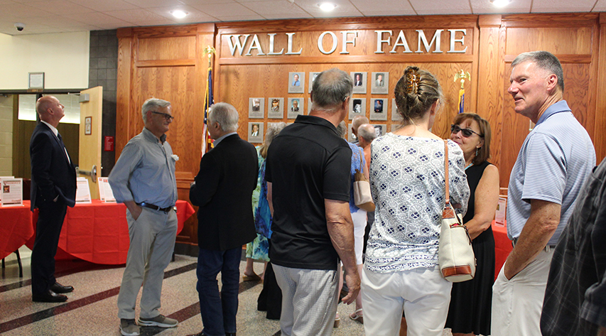 People gather in front of the wall of fame