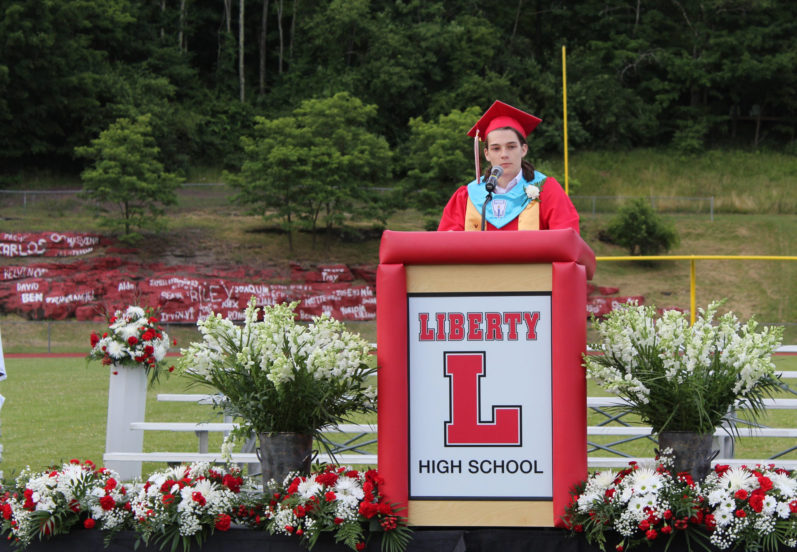 A graduate speaks at a podium