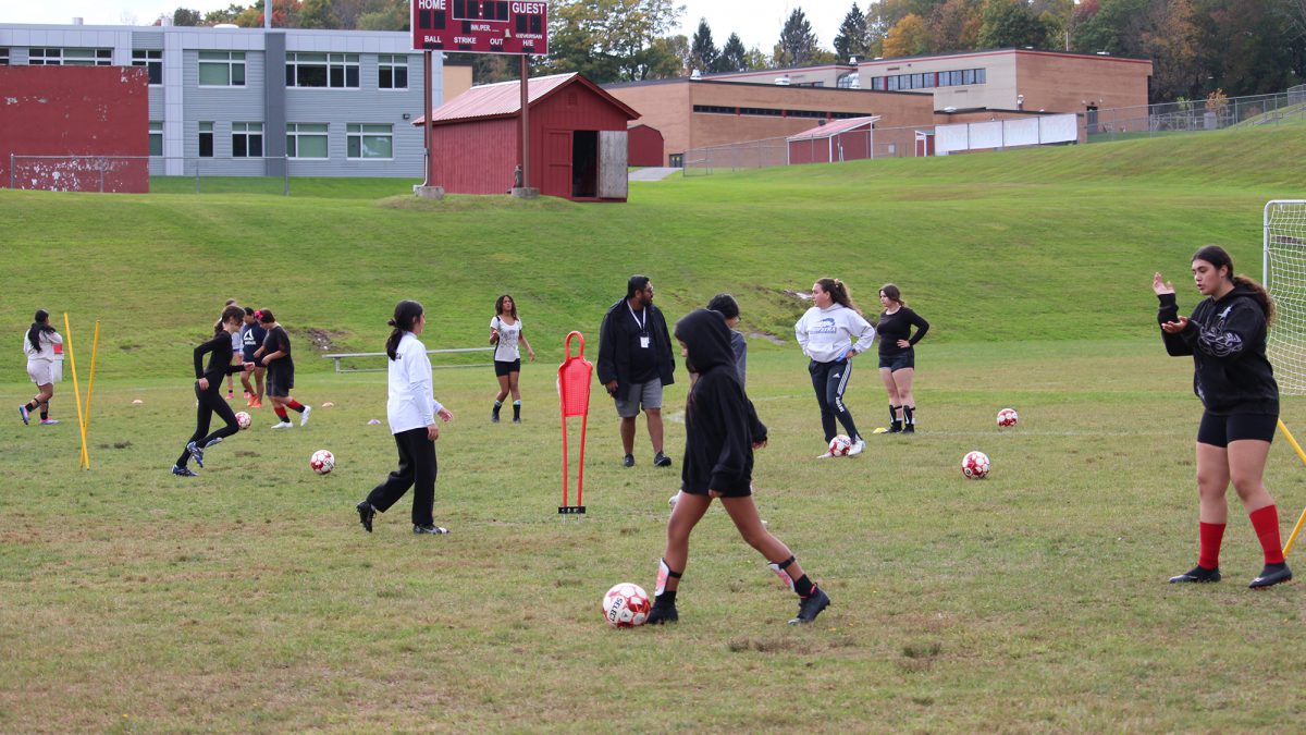 Student soccer players practice