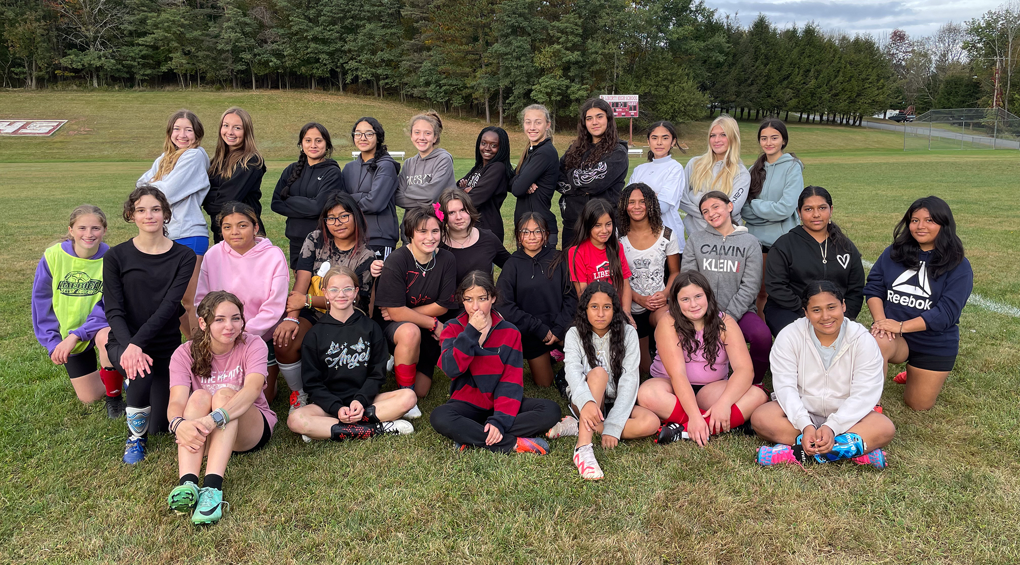 Girls soccer players pose for a photo after practice