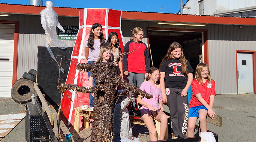 Students pose for a photo on a Halloween float