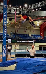 A girl clears a height in pole vault