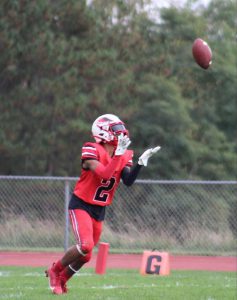 A football player prepares to catch a football.