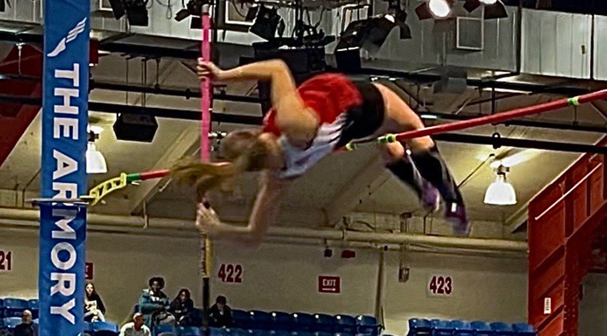 An athlete clears the bar in pole vault