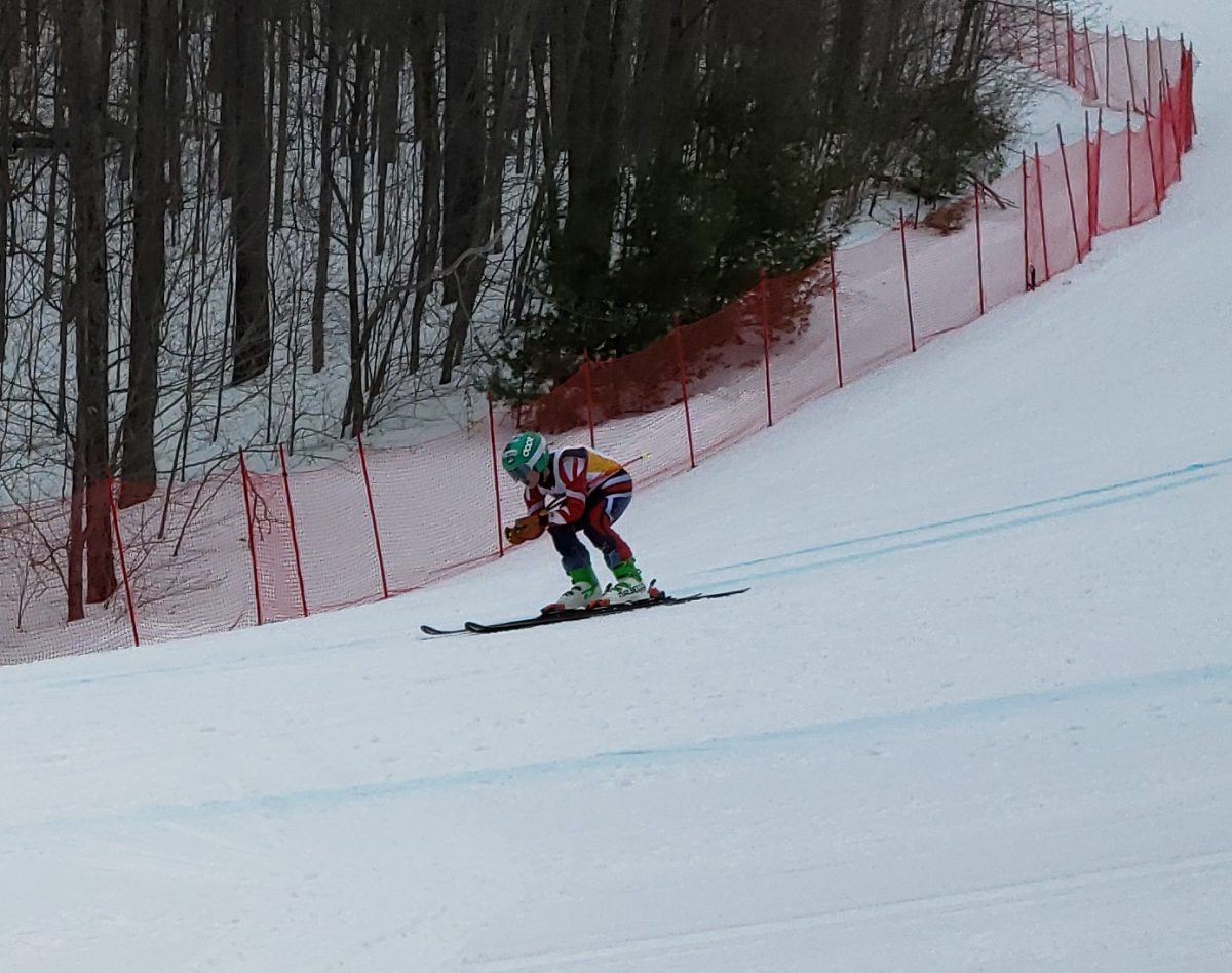 A skier races down the slopes