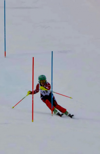 A downhill skier goes through gates 